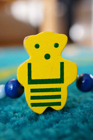 A vertical shot of a yellow bear on a blue surfaceの写真素材