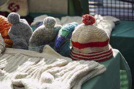 A selective focus shot of wool hats with a blurred backgroundの写真素材