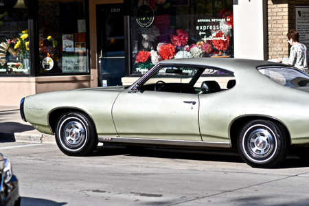 DOWNERS GROVE, UNITED STATES - Jun 07, 2019: A shiny vintage car parked at the side of the streetのeditorial素材