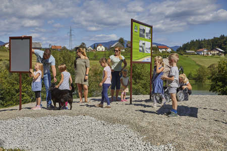 CELJE, SLOVENIA - Sep 10, 2019: Group of toddlers and their parents playing and enjoying on natural playground near the lake.のeditorial素材