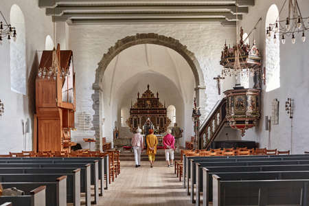AAKIRKEBY, DENMARK - Jun 27, 2019: Aakirkeby, Bornholm island, Denmark - 27 June 2019. Tourists visiting Aa Church (Aa Kirke) - a Romanesque church dating from the 12th centuryのeditorial素材