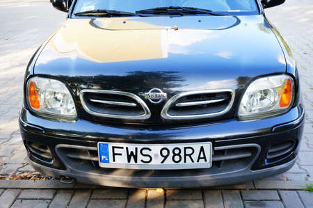 POZNAN, POLAND - Sep 20, 2014: Parked black Nissan Micra on a parking spot at the Osiedle Piastowskie area.のeditorial素材
