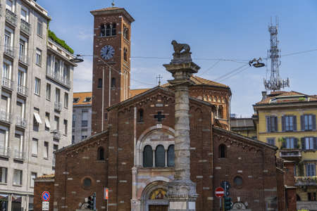 The San Babila surrounded by apartment buildings under the sunlight in Milan in Italyのeditorial素材
