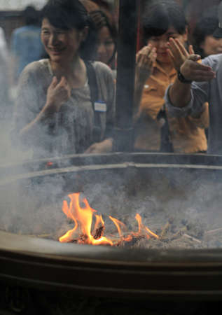 TOKYO, JAPAN - Sep 09, 2019: 09 September 2019 - Tokyo, Japan: Vistors at Sensoji Temple in Asakusa covering themselves with smoke. People believe in its healing properties.のeditorial素材