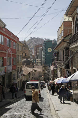 LA PAZ, BOLIVIA - Sep 09, 2019: 09 September 2019 - La Paz, Bolivia: People and cars on the steep streets of La Paz, Bolivia, with many more buildings on the hills in the background.のeditorial素材