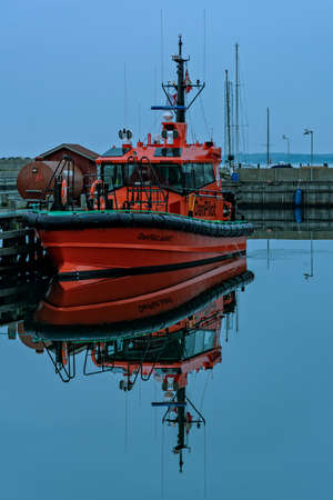 Motorboat moored in a small Baltic Sea port in Denmarkのeditorial素材