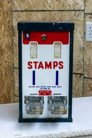 MASON, UNITED STATES - Jul 09, 2019: An antique stamps machine in a vintage store in the United...