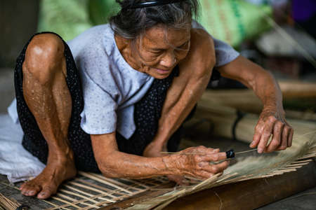HANOI, VIETNAM - Sep 20, 2019: A selective focus shot of a busy person concentrated on work  in Hanoi, Vietnamのeditorial素材