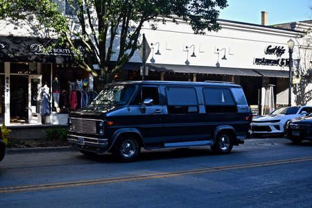DOWNERS GROVE, UNITED STATES - Jun 07, 2019: A black compact van in a busy roadのeditorial素材