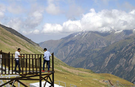 ALMATY, KAZAKHSTAN - Sep 09, 2019: 09 September 2019 - Almaty, Kazakhstan: Two young men taking selfies and photos of each other on a construction in the mountains outside Almaty.のeditorial素材