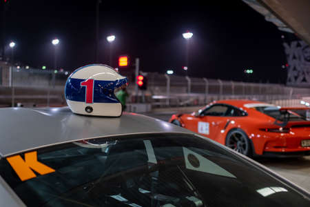 January 25, 2019 - Abu Dhabi, UAE:  Car racing driverâs helmet placed on the roof of Porsche carのeditorial素材