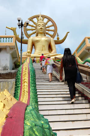 KOH SAMUI, THAILAND - Mar 27, 2019: Tourists visiting the large Buddha Statue found at the Wat Phra Yai temple near Bang Rak beach in Koh Samui, Thailand.のeditorial素材