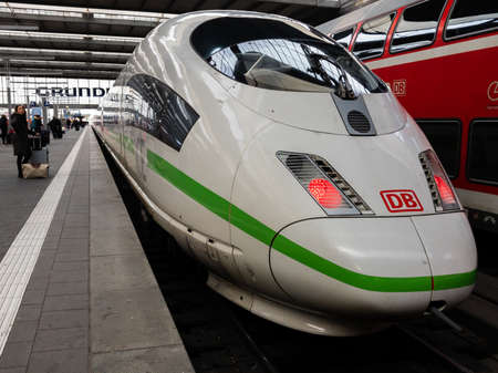 MUNICH, GERMANY - Jan 29, 2020: Front of a modern ICE of the Deutsche Bahn with green stripes,...