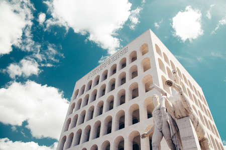 A low angle shot of Palazzo della CiviltÃ  Italiana or Colosseo Quadrato under blue sky with clouds in Rome, Italyのeditorial素材