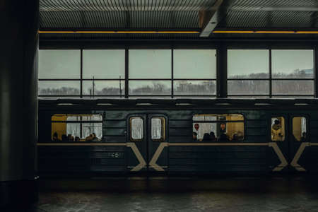 A green train stopped at a railway stationのeditorial素材