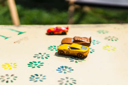 POZNAN, POLAND - Jul 29, 2018: Mix of Pixar Disney Cars toys on a table in soft focus on a sunny day.のeditorial素材