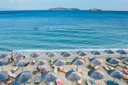 A wide shot of a beach lounge on seashore by the sea in Skiathos, Greeceのeditorial素材