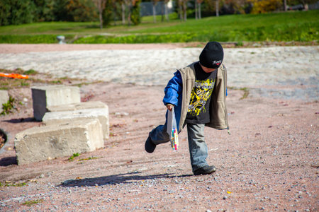 MONTREAL, CANADA - Oct 16, 2010: Montreal, Quebec / Canada - October 16 2010: Small Blond Boy Wearing a Blue Jacket is Playing in the Park Aloneのeditorial素材