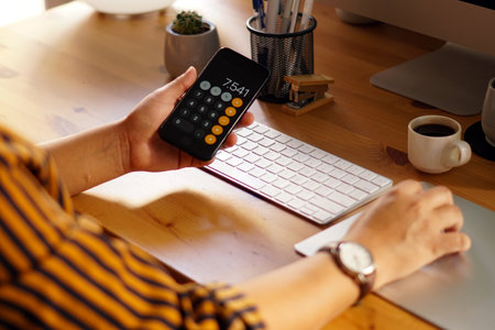 A closeup shot of an entrepreneur working from home and doing calculationsの写真素材