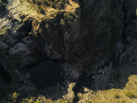 An aerial shot of a pond near a cliff at the Arribes del Duero in Salamanca, Spainの写真素材