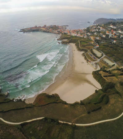 An aerial vertical shot of buildings near the sea in Galicia, Spain