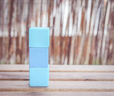 A stack of blue toy blocks on a wooden tableの写真素材