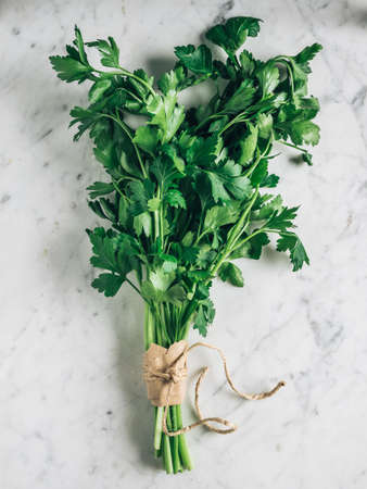 A bunch of fresh green parsley on white backgroundの写真素材