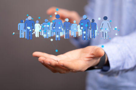 A 3D rendering of people silhouettes in the network team with a real person holding itの写真素材
