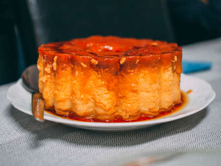A tasty cake with syrup on it on the tableの写真素材