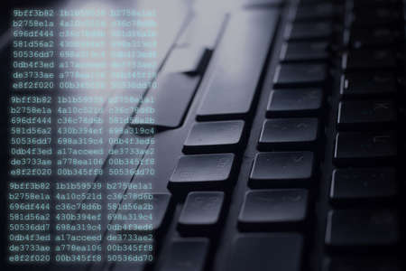 A closeup shot of a black computer keyboard with codes on the side