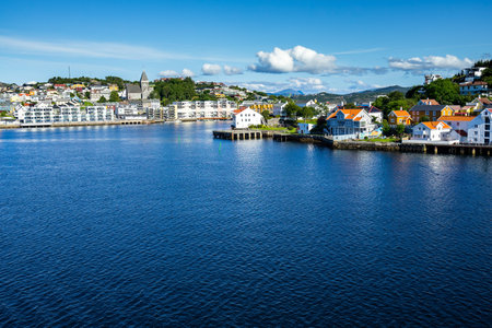 The sea with boats on it surrounding Kristiansund under the sunlight in Norwayの写真素材