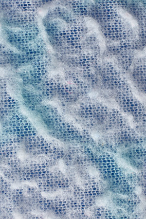 A vertical closeup shot of a fuzzy blue surface
