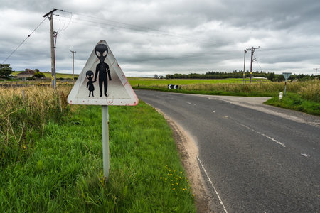 A humorous weathered danger road sign warning of possible UFO in Scotlandの写真素材