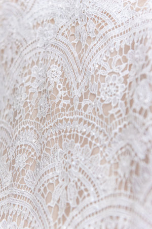 A vertical closeup shot of beautiful details of a wedding dressの写真素材