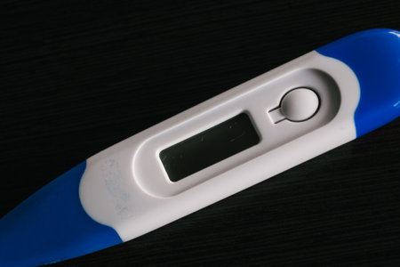 A closeup shot of a thermometer isolated on a black backgroundの写真素材