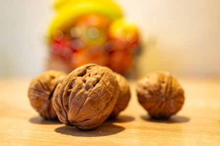 A close up shot of walnuts on a kitchen table