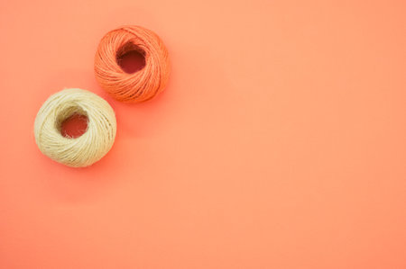The yarn balls for knitting isolated on orange background