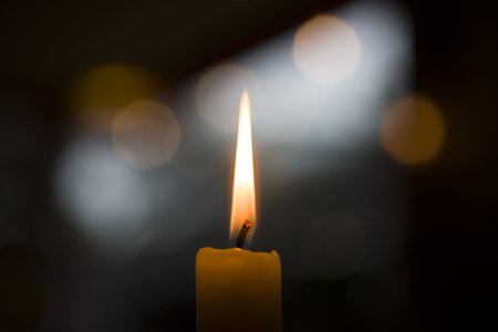 A beautiful shot of candlelight with a light effect on the black background
