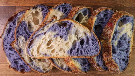 A closeup shot of sourdough bread on a wooden tableの写真素材