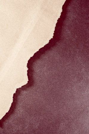 A vertical shot of a natural recycled paper on a dark stone background - copy spaceの写真素材