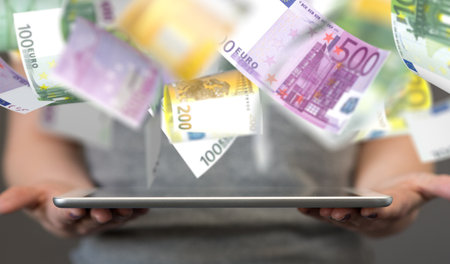 A businessman presenting the virtual projection of euro billsの写真素材