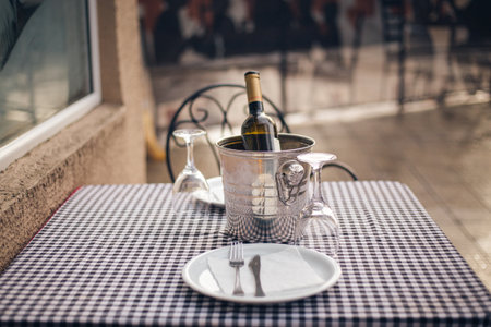 A selective focus shot of an ice bucket with a wine bottle in a cafeの写真素材