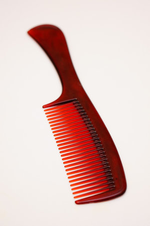 A vertical shot of a new comb isolated on a white surfaceの写真素材