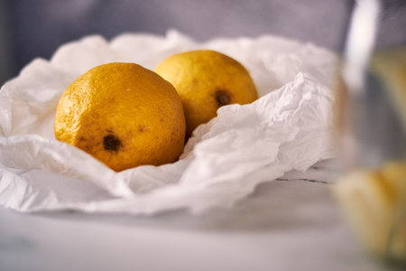 A beautiful shot of fresh lemons in a white packageの写真素材