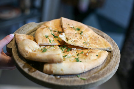 A selective focus shot of focaccia on a wooden board