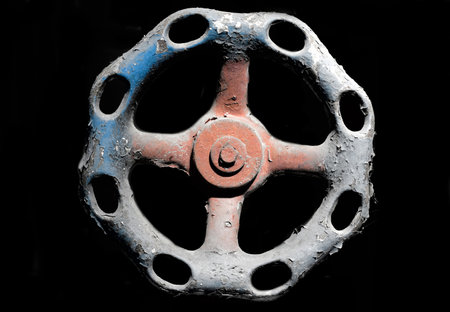 Old Faucet Knob on Black Background in Switzerland.の写真素材