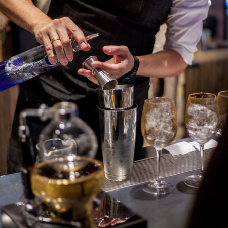 The bartender making an alcoholic cocktail, a summer cocktail in the barの写真素材