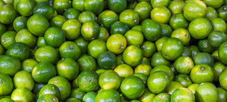 A closeup shot of unripe lemons in a store