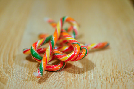 The colorful candy canes on a wooden surface - perfect for background