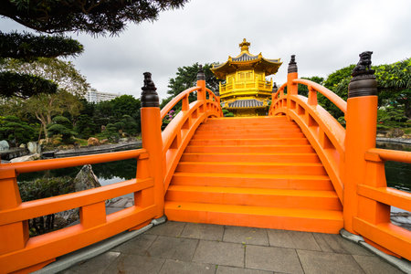 An orange bridge leading to the Golden Pavilion of Absolute Perfection, Chi Lin Nunnery, Hong Kongの写真素材